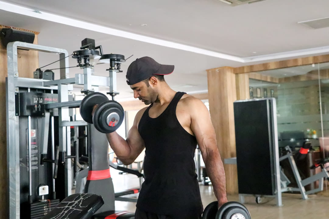 a man in a gym holding a dumbbell on First Rep Forward