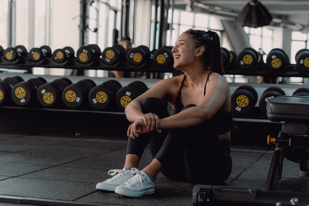 A woman sitting on the ground in a gym on First Rep Forward