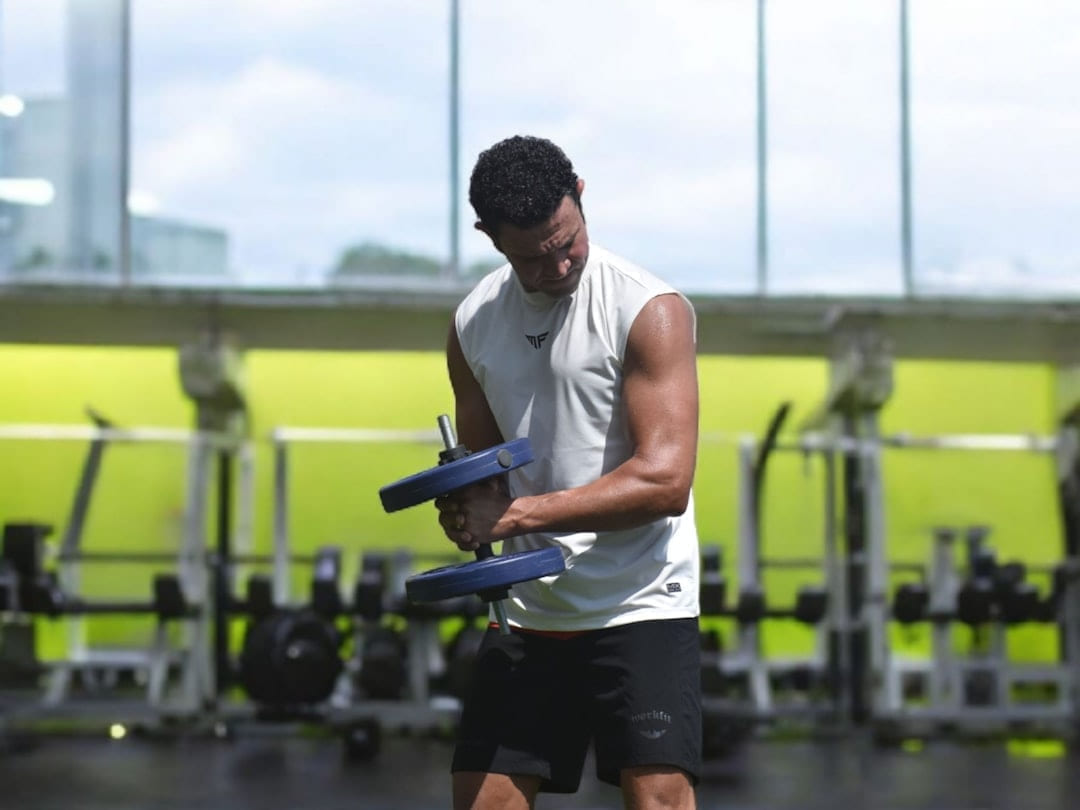 Man lifting weights in a gym on First Rep Forward