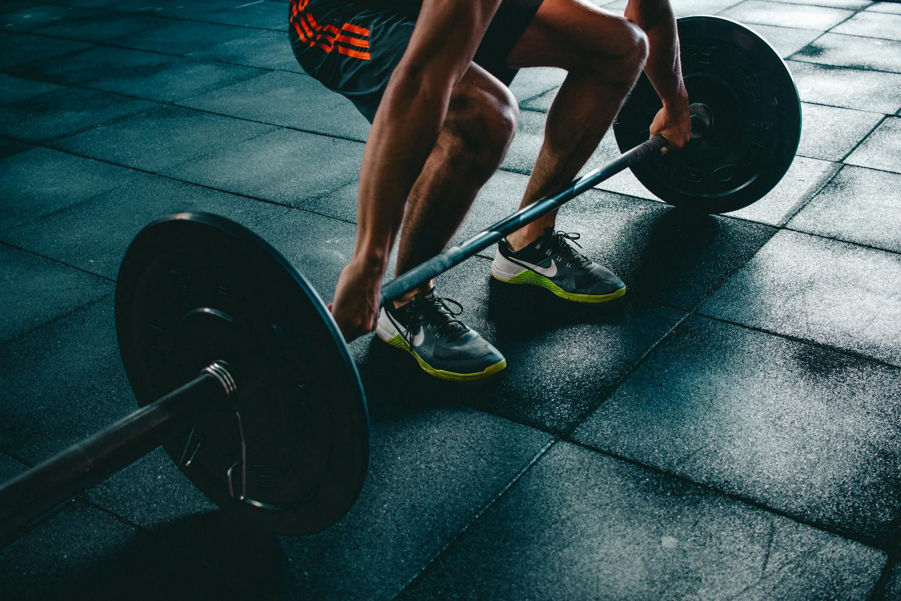 Man performing a deadlift exercise in a gym, demonstrating strength and fitness. on First Rep Forward