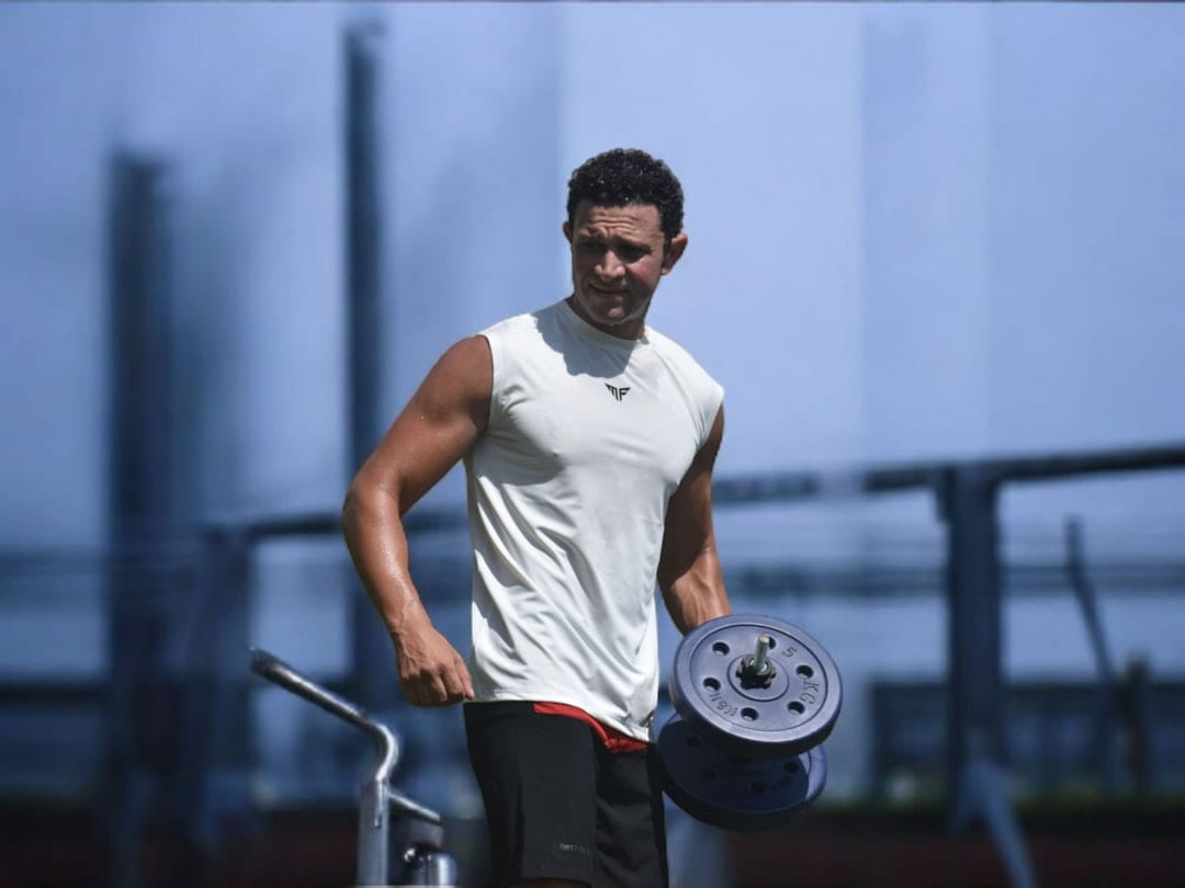 Man lifting weights at an outdoor gym. on First Rep Forward