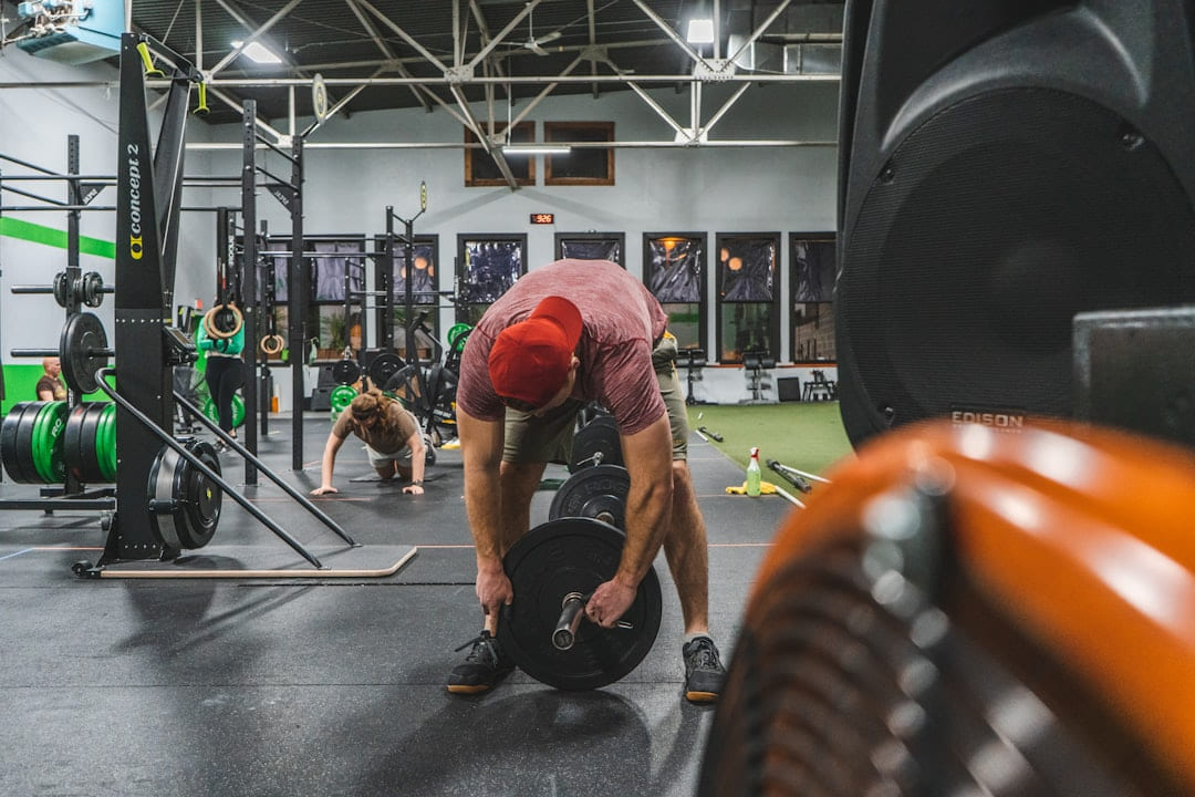 a man squatting down in a crossfit gym on First Rep Forward