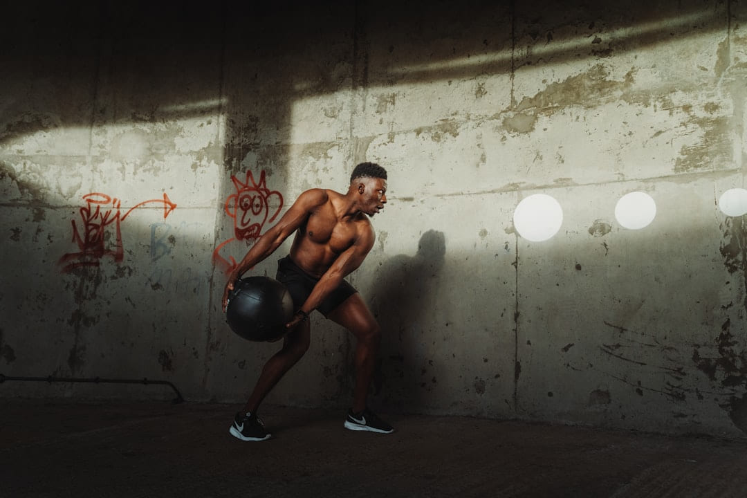 a man lifting weights on First Rep Forward